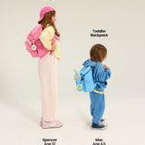 Two children with backpacks labeled 'Kids Backpack' and 'Toddler Backpack' on a plain background. pop pink jet blue