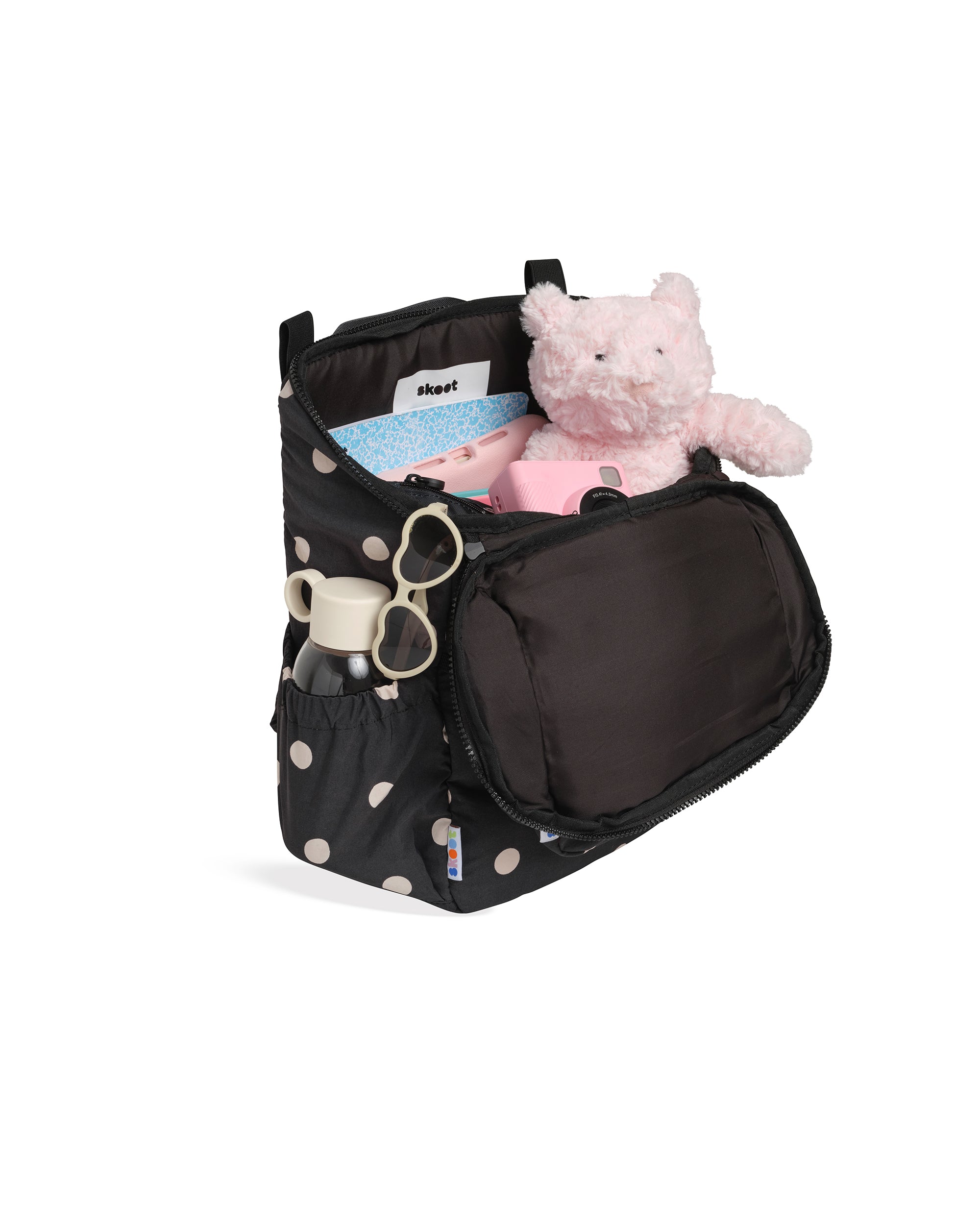 skoot polka dot kids backpack outside unzipped filled up with kids toys