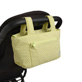 green gingham skoot stroller caddy attached to a stroller