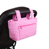 pink gingham skoot stroller caddy attached to a stroller