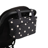 polka dot skoot stroller caddy attached to a stroller