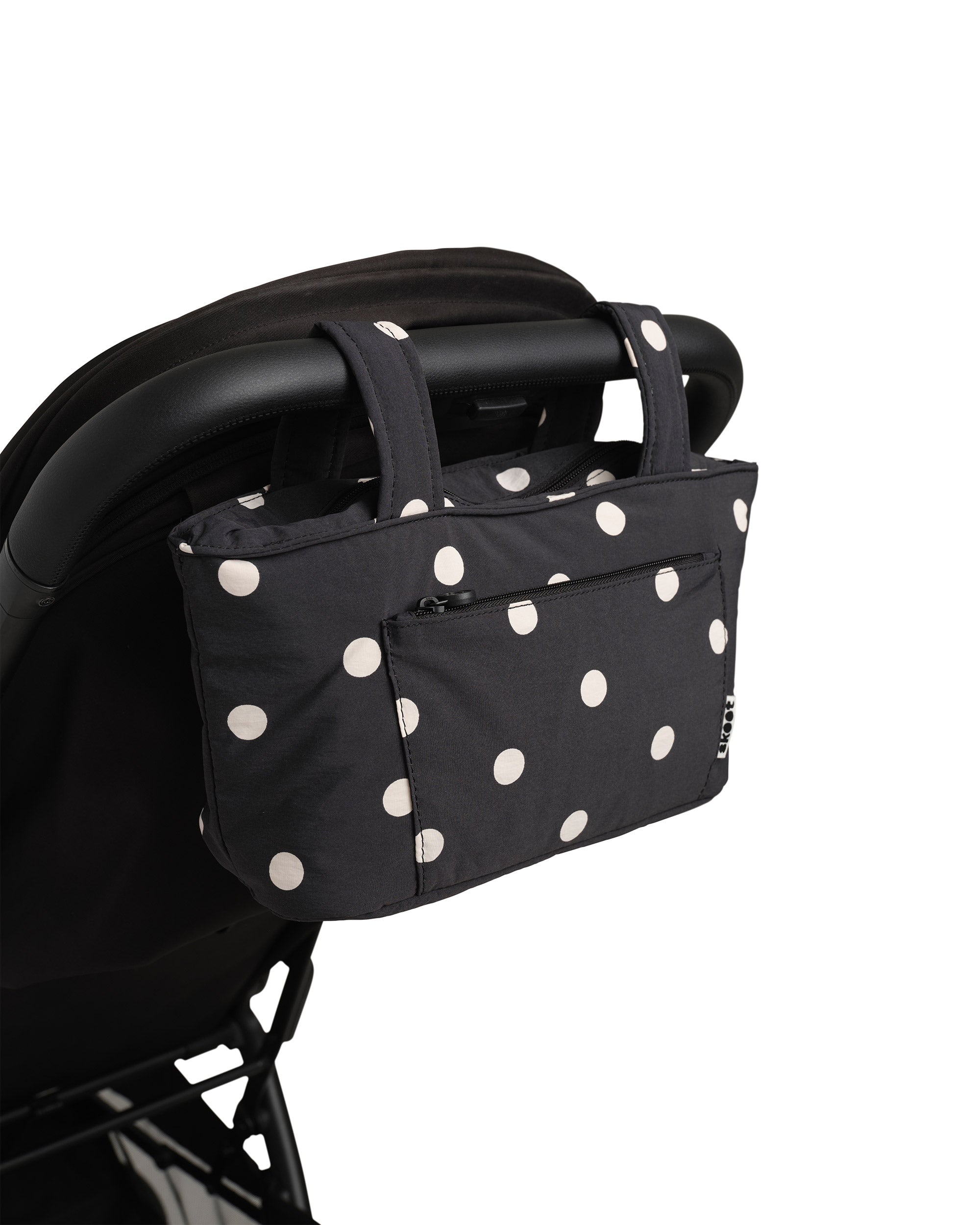 polka dot skoot stroller caddy attached to a stroller