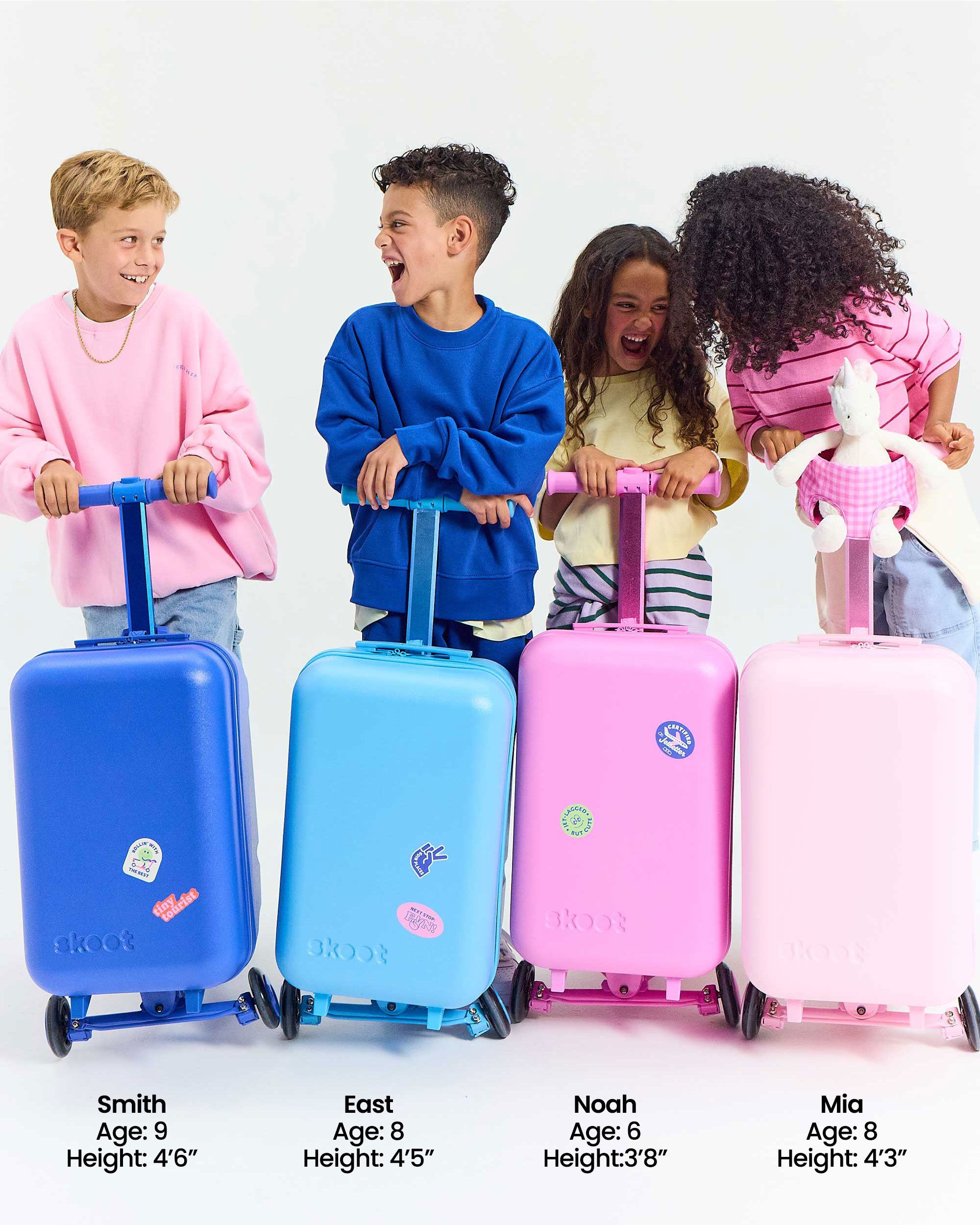 group photo of kids with the skoot skootcases puff pink pop pink jet blue sky blue go green