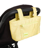 green gingham skoot stroller caddy attached to a stroller