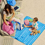 madi nelson and child in an airport using the blue gingham snack size mat