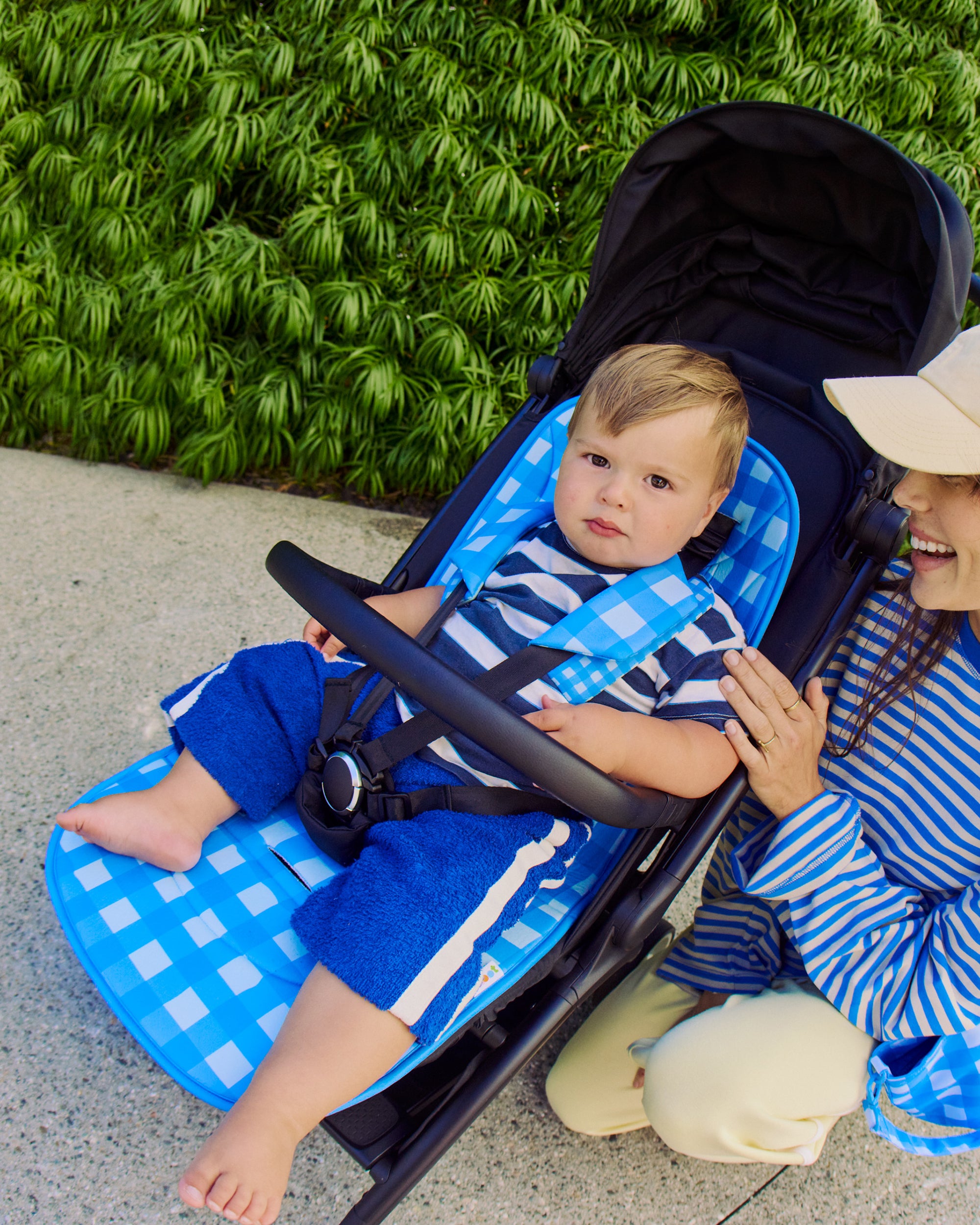 little boy on skoot blue gingham stroller liner